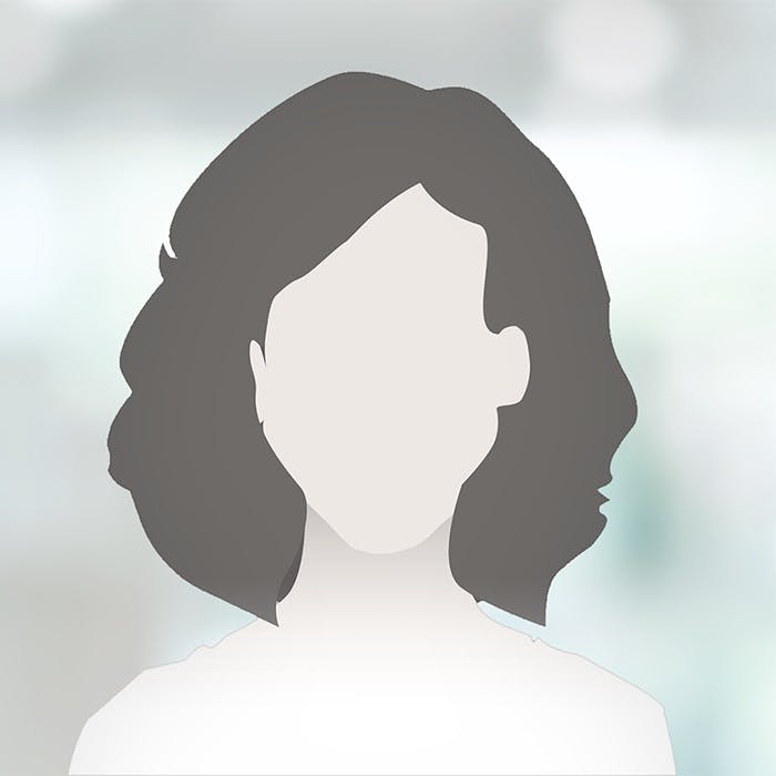 Silhouette of an anonymous female person with medium-length hair against a blurred background.